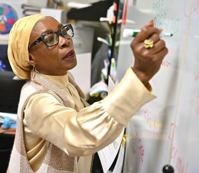 GGC graduate Dorah Nsemoh sharing a lesson on the whiteboard