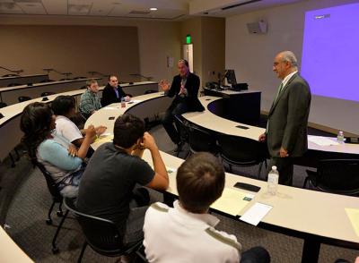 Guest speaker and alum speaking to business majors