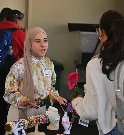 student entrepreneur showing jewelry during the business expo