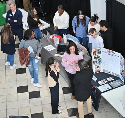 Students viewing displays during the business expo