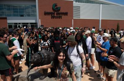 Students rubbing grizzly statue nose at the 2025 First-Year Convocation ceremony