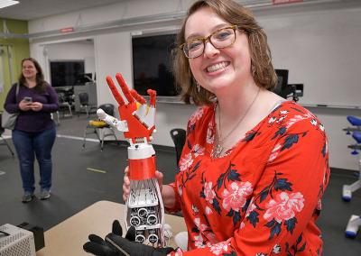 GGC student demonstrating robotic arm project at science event