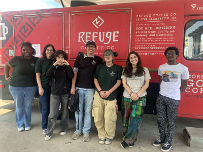 Group of GGC students standing in front of a red truck during Alternative Spring Break 2026 in Clarkston
