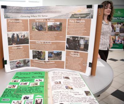 Poster board filled with information related to the 2026 Alternative Spring Break ePortfolio Showcase