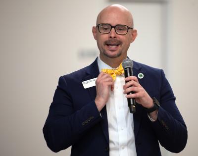 Dr. Matthew Robison holding a microphone speaking at the 2026 Elite Scholars Summit